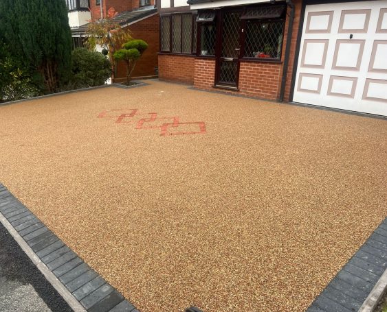 Resin Bound Gravel driveway with red markings and decorative border.